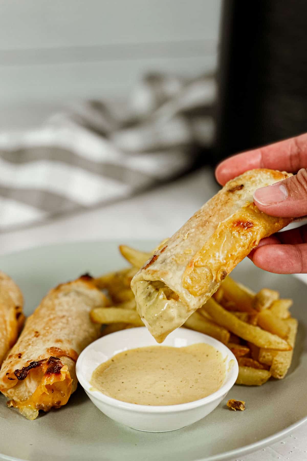 Big Mac Egg Rolls Air Fryer Recipe bite shot, with dipping sauce and fries
