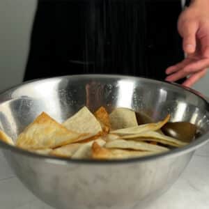 seasoning tortilla chips with salt