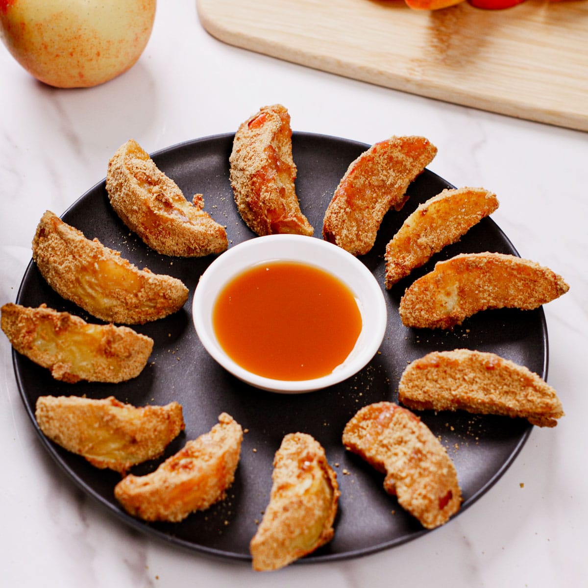 Air fried apple wedges served with caramel dipping sauce