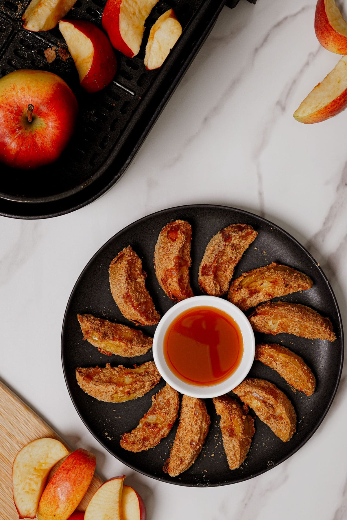 Air fryer apple fries recipe bite shot, served with caramel dipping sauce.
