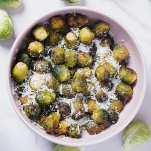 Air Fryer Frozen Brussels Sprouts served in a bowl, with parmesan cheese