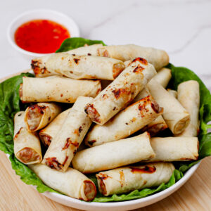 Air fryer frozen spring rolls, served with traditional sweet and spicy sauce