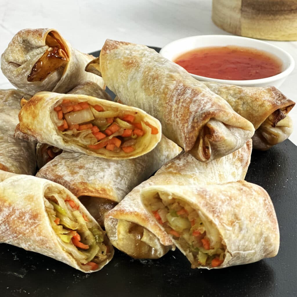 Air fryer vegetable egg rolls served with sweet chili sauce