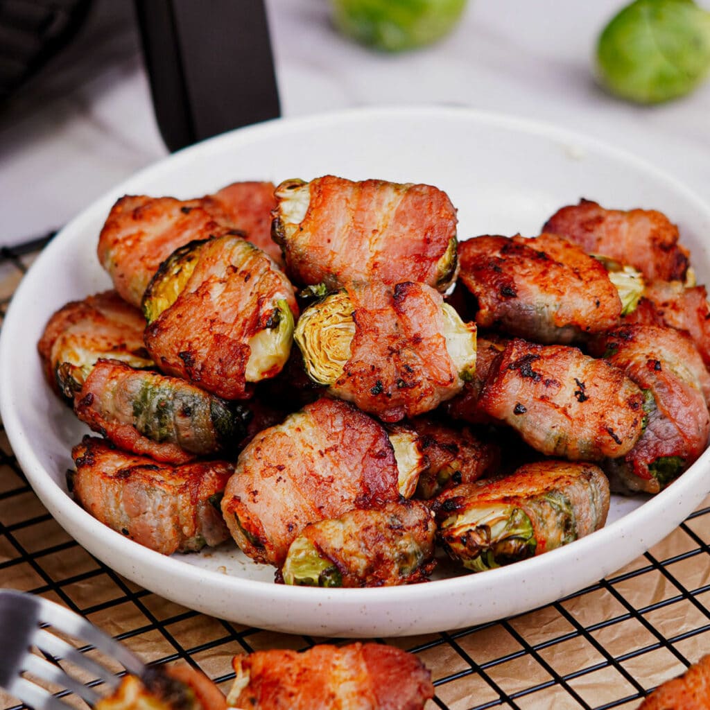 Bacon wrapped Brussels sprouts air fryer recipe served in a plate.