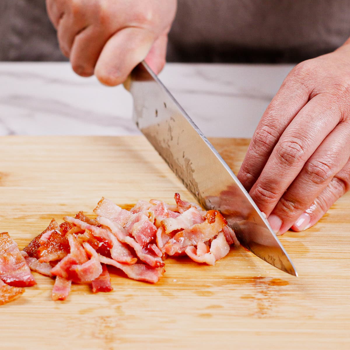 Chopping bacon into small strips