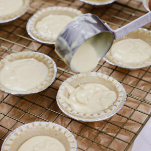 Step 5: Filling frozen pastry cups with custard mixture.
