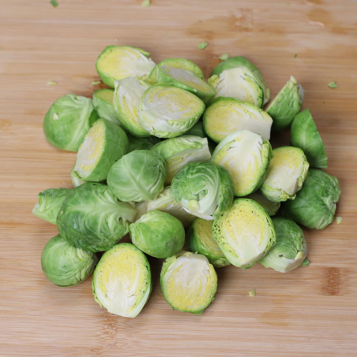Halved brussels sprouts on a chopping board