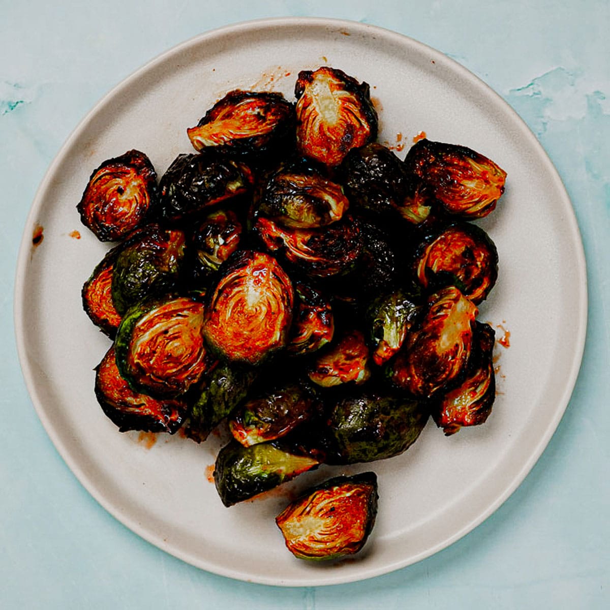 Honey sriracha Brussels sprouts air fryer recipe served in a white plate