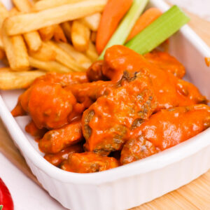 Air fryer Buffalo chicken wings, served with fries, celery and carrots.