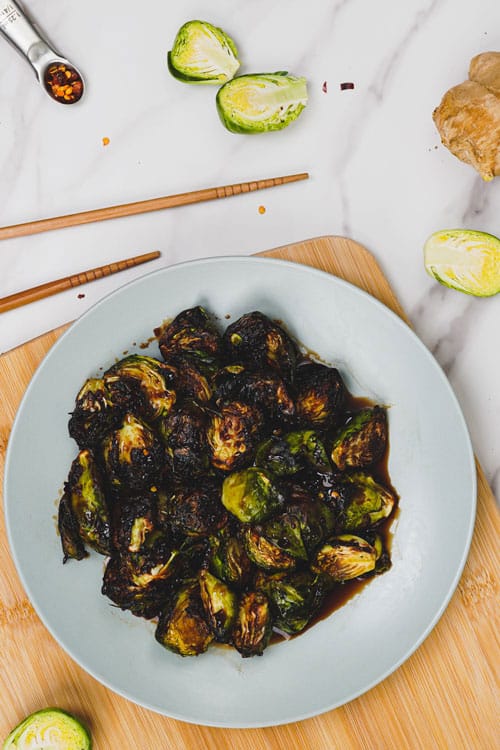 Asian Brussels sprouts air fryer recipe bite shot, served on a plate.
