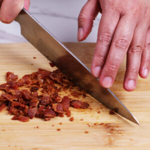Chopping bacon bits.
