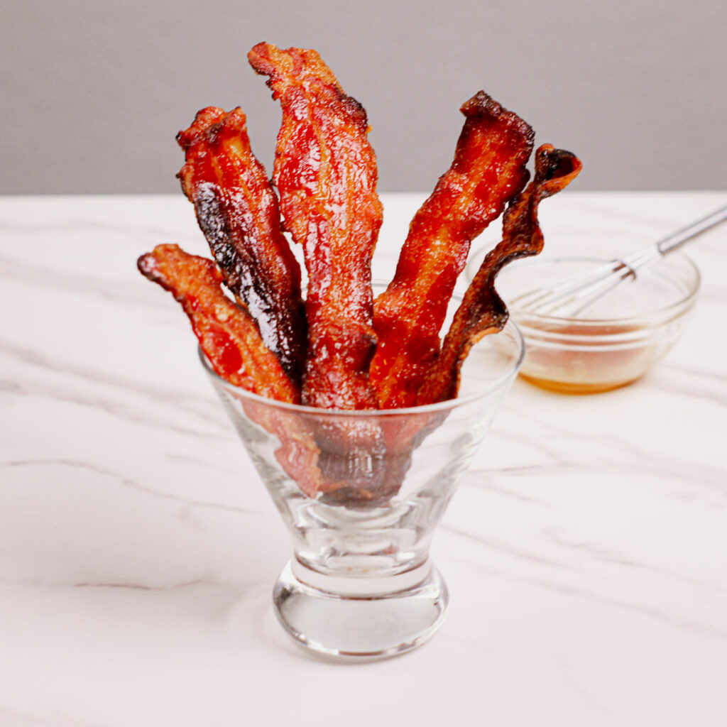Candied bacon air fryer recipe served in a cocktail glass.