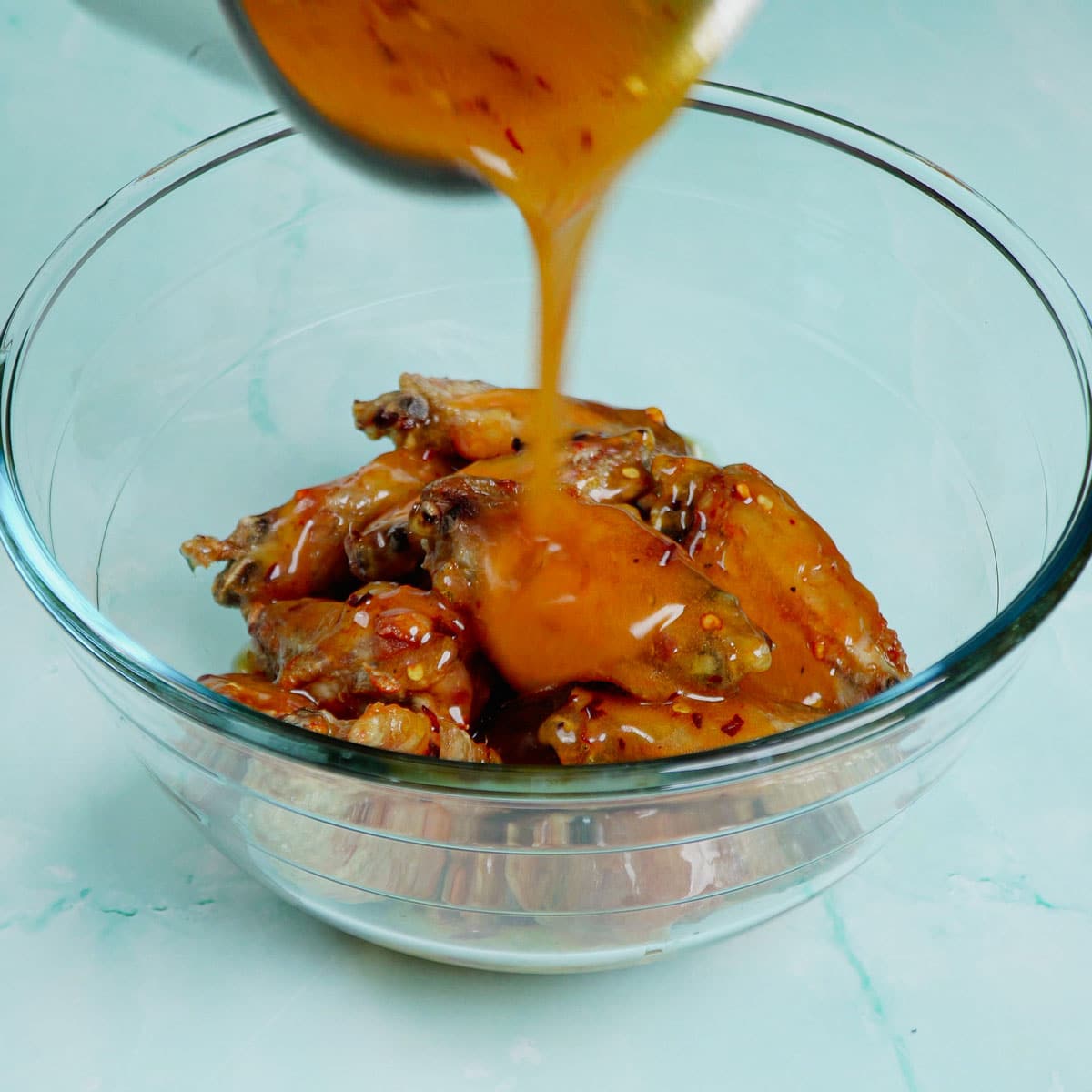 Coating wings with hot honey sauce