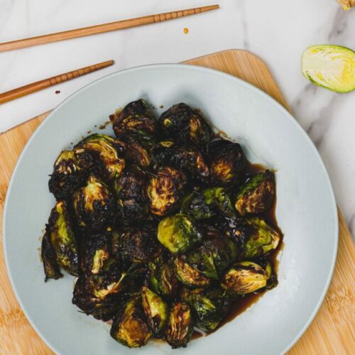 Asian Brussels sprouts air fryer recipe bite shot, served on a plate.