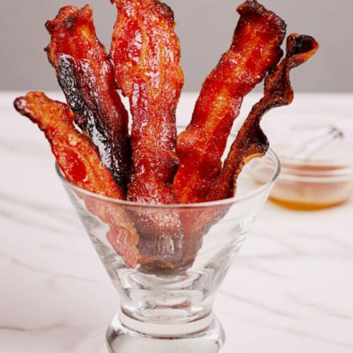 Candied bacon air fryer recipe bite shot served in a cocktail glass.