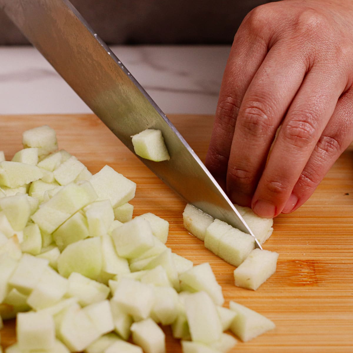 Dicing apples on chopping board