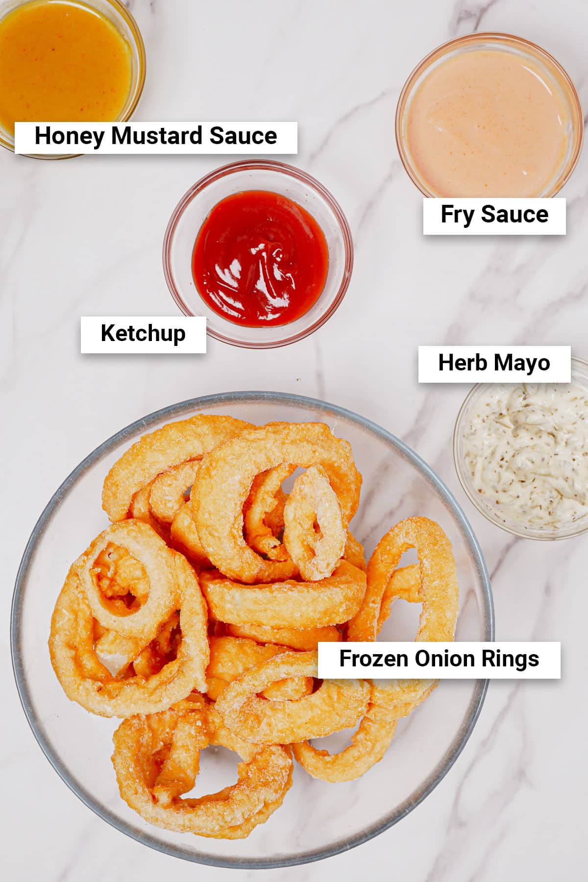 Frozen onion rings with 4 sauce options: honey mustard, herb mayo, ketchup, traditional fry sauce.