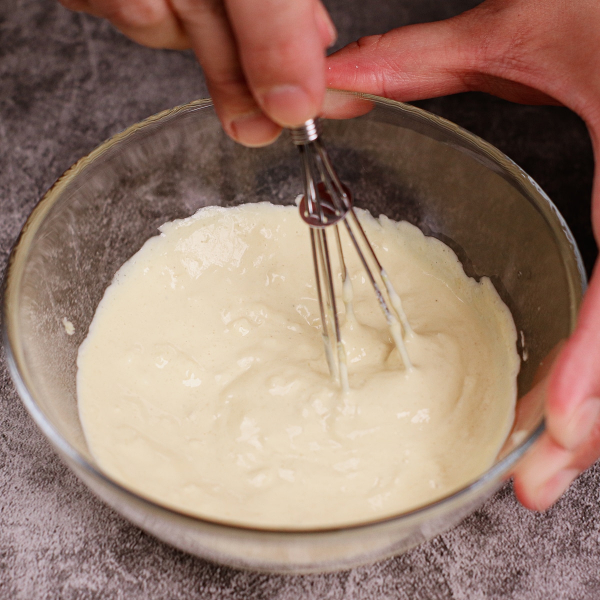 Mixing garlic mayo paste in a small bowl.
