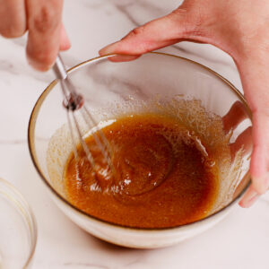 Step 4: Mixing sugar and maple syrup in a small glass bowl.
