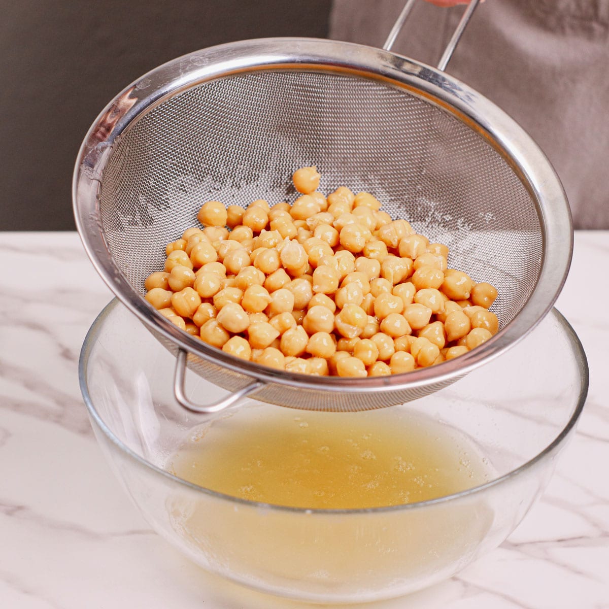 Rinsing garbanzo beans in a strainer.