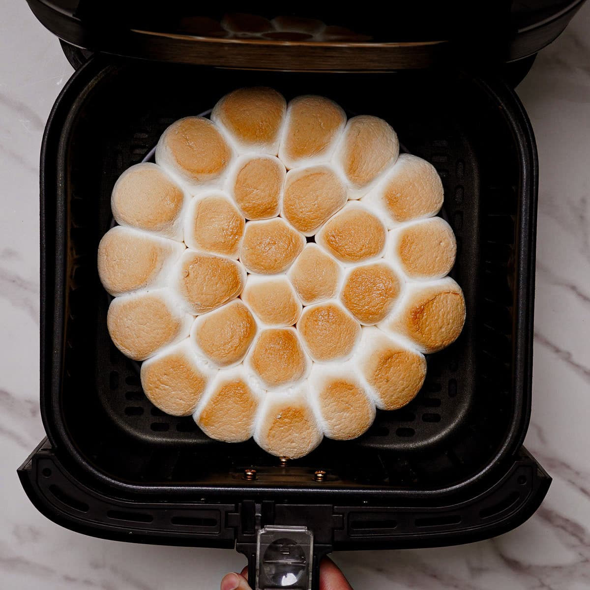 Cooking s'mores dip in air fryer.