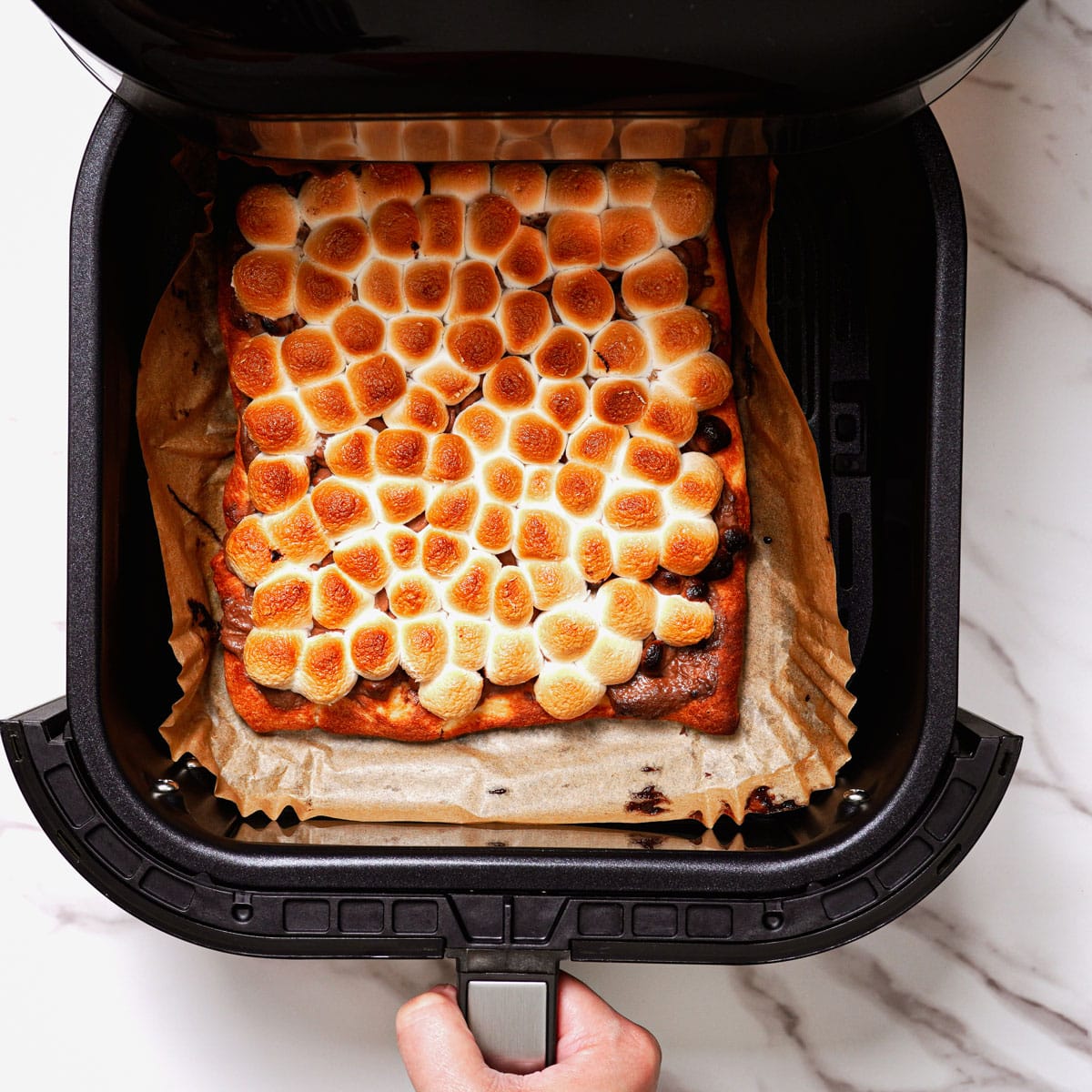 Cooking s'mores pizza in air fryer.
