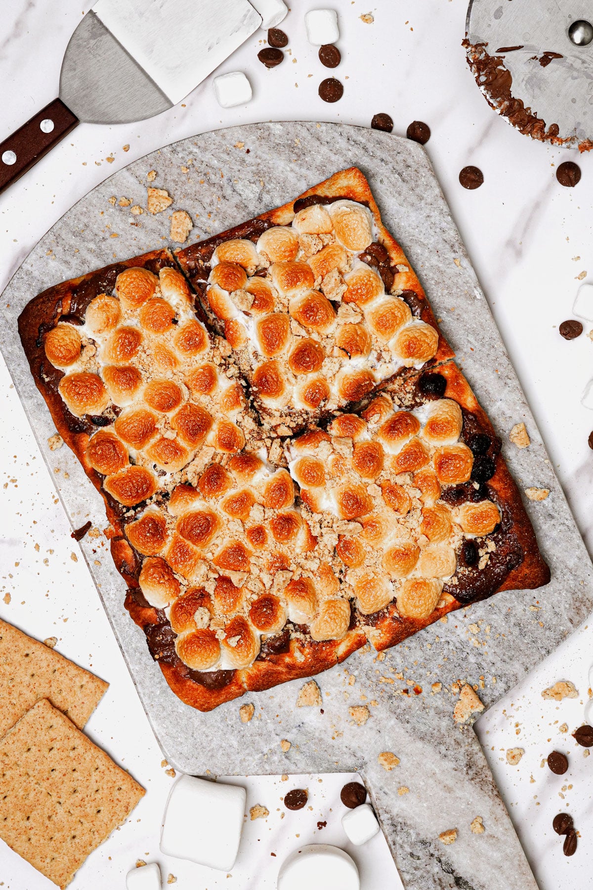 Air fryer s'mores pizza recipe bite shot, on a marble serving board.