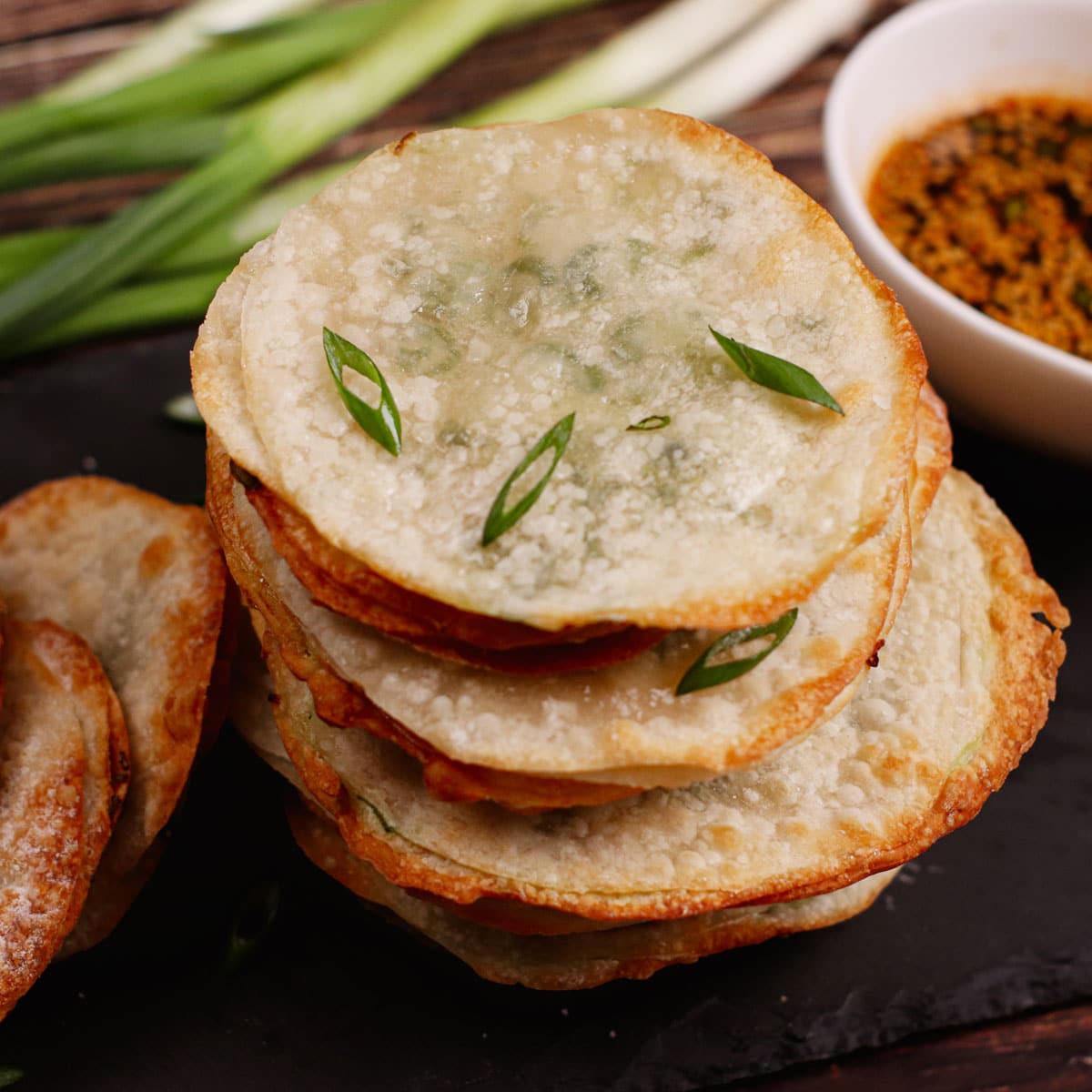 Air fried scallion pancakes, stacked with special dipping sauce.