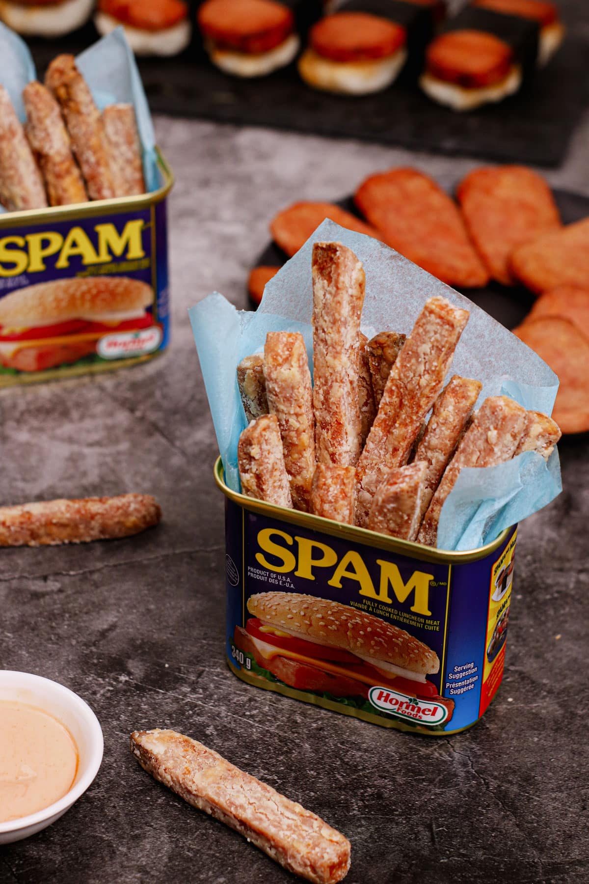 Air fryer spam fries recipe bite shot, served in a can of spam with fry dipping sauce on the side.
