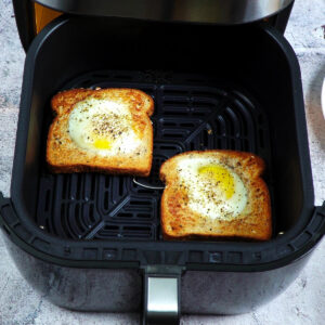 Air frying eggs in a nest, first round of cooking at 360°F (182°C),