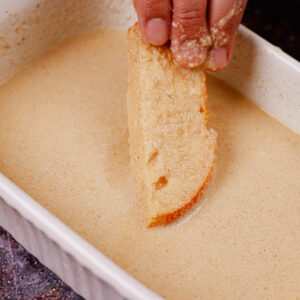 Dipping bread strips in the custard mixture.