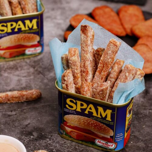 Air fryer spam fries recipe bite shot, served in a can of spam with fry dipping sauce on the side.