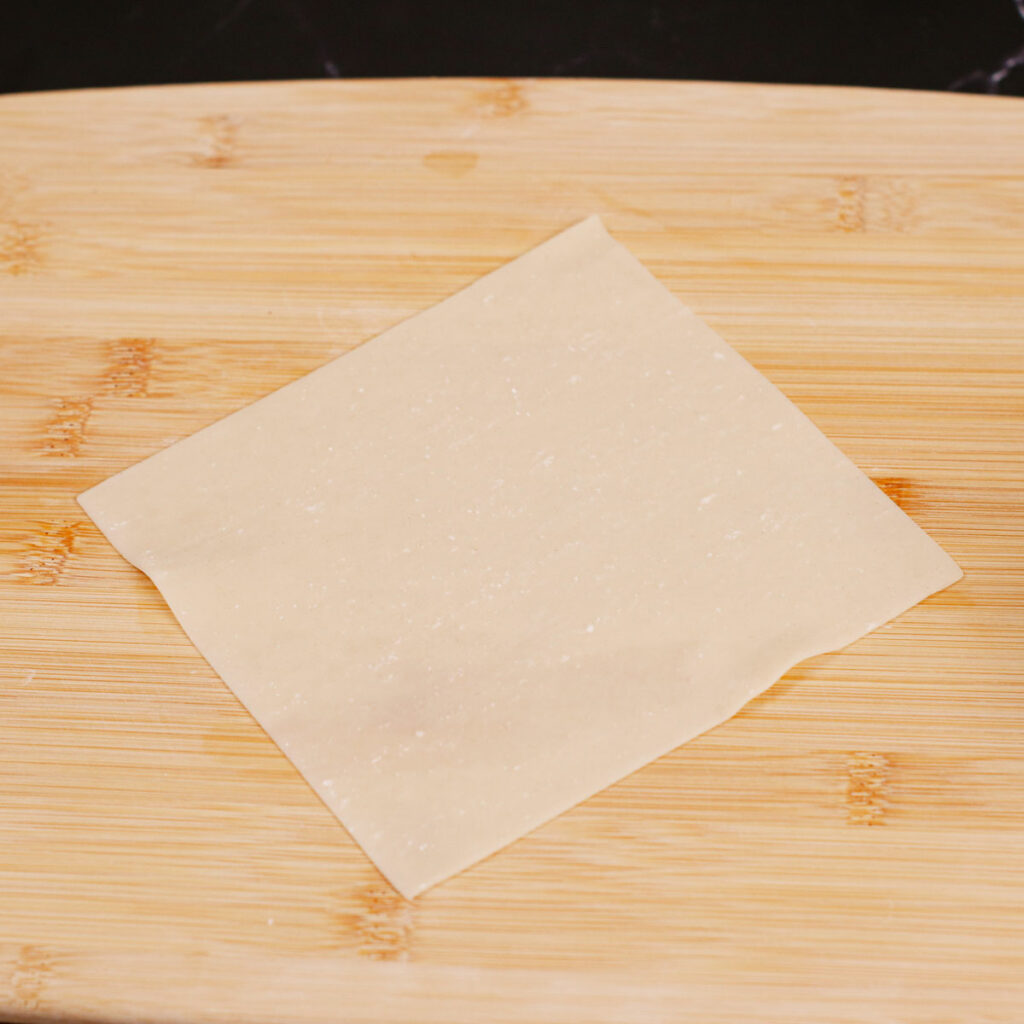 Step 1: Place egg roll wrapper on a chopping board