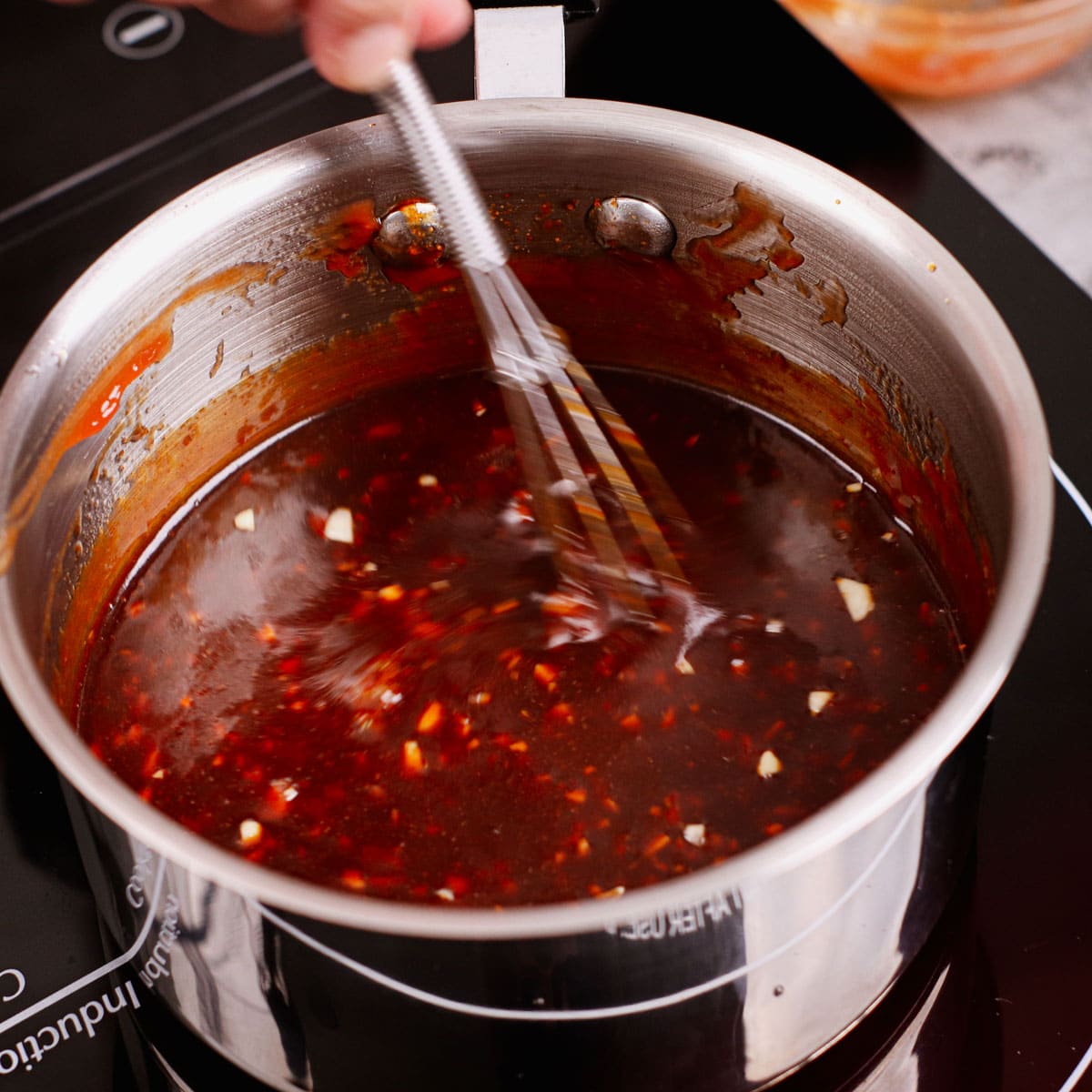 Making Korean spicy chicken sauce in a saucepan.