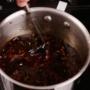 Reducing Mongolian sauce in a saucepan.