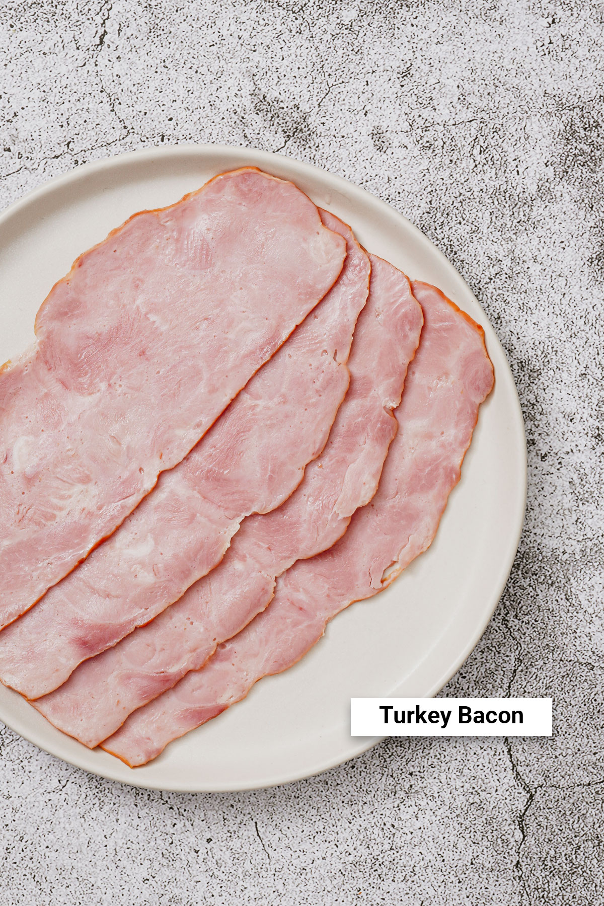 Turkey bacon strips on a white plate