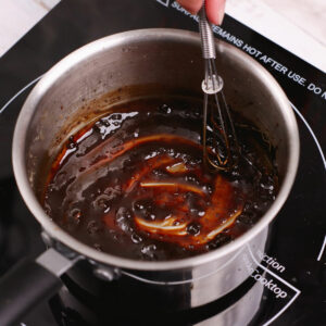 Reducing adobo marinade in a saucepan