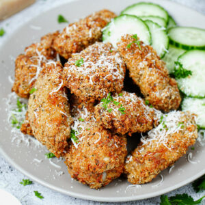 Air fried garlic parmesan wings sprinkled with shredded parmesan and cucumber slices.