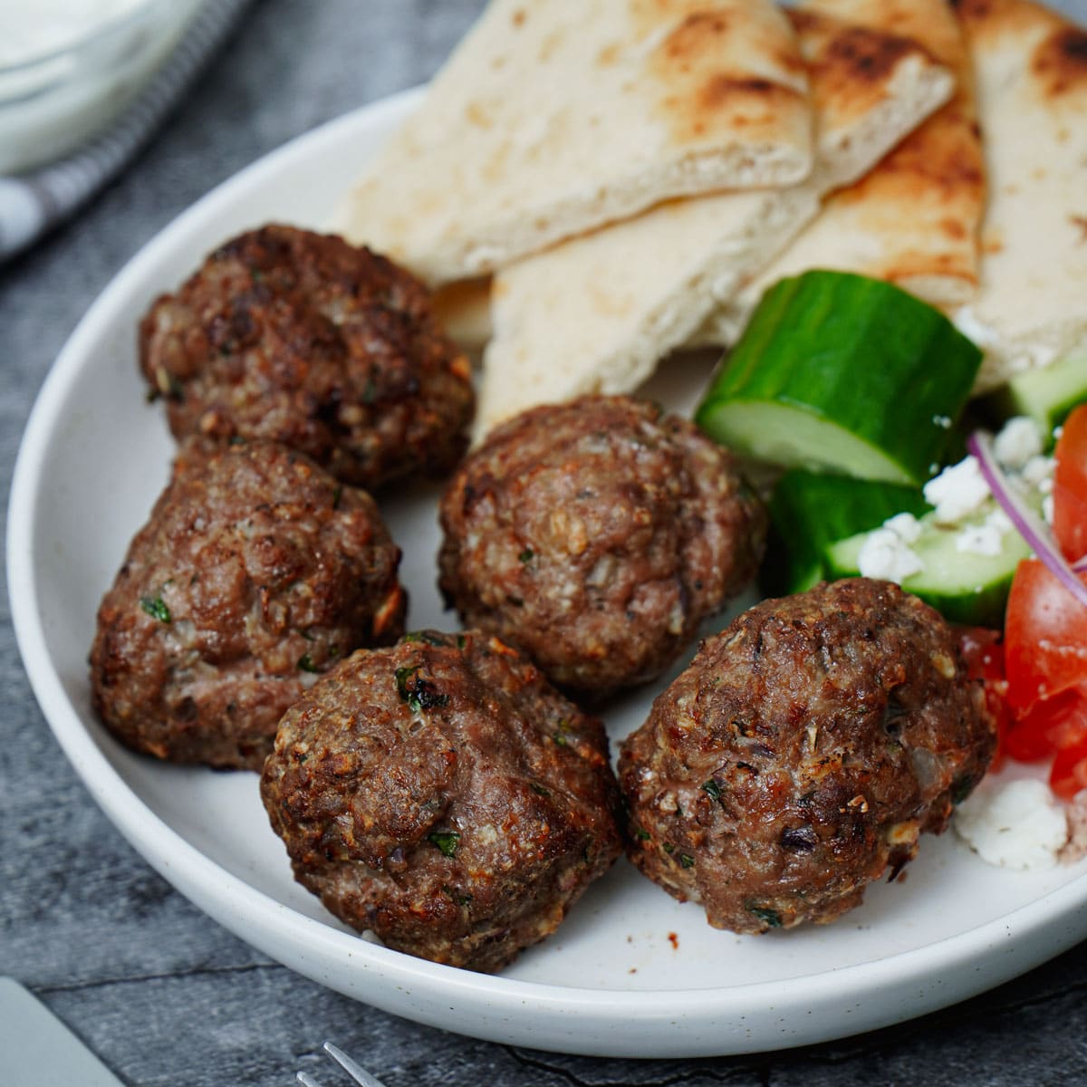 Air Fried Greek Meatballs served with vegetables and pita bread.