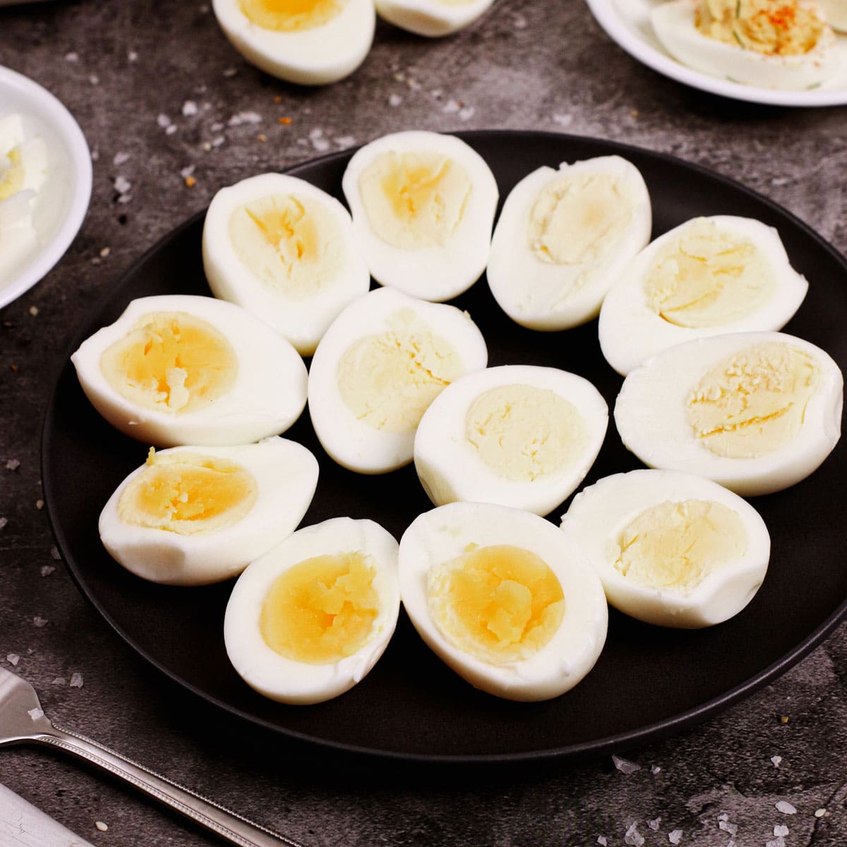 Air fried hard boiled eggs on a black plate