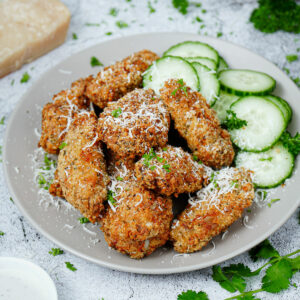Air fryer garlic parmesan wings with cucumber slices on the side.