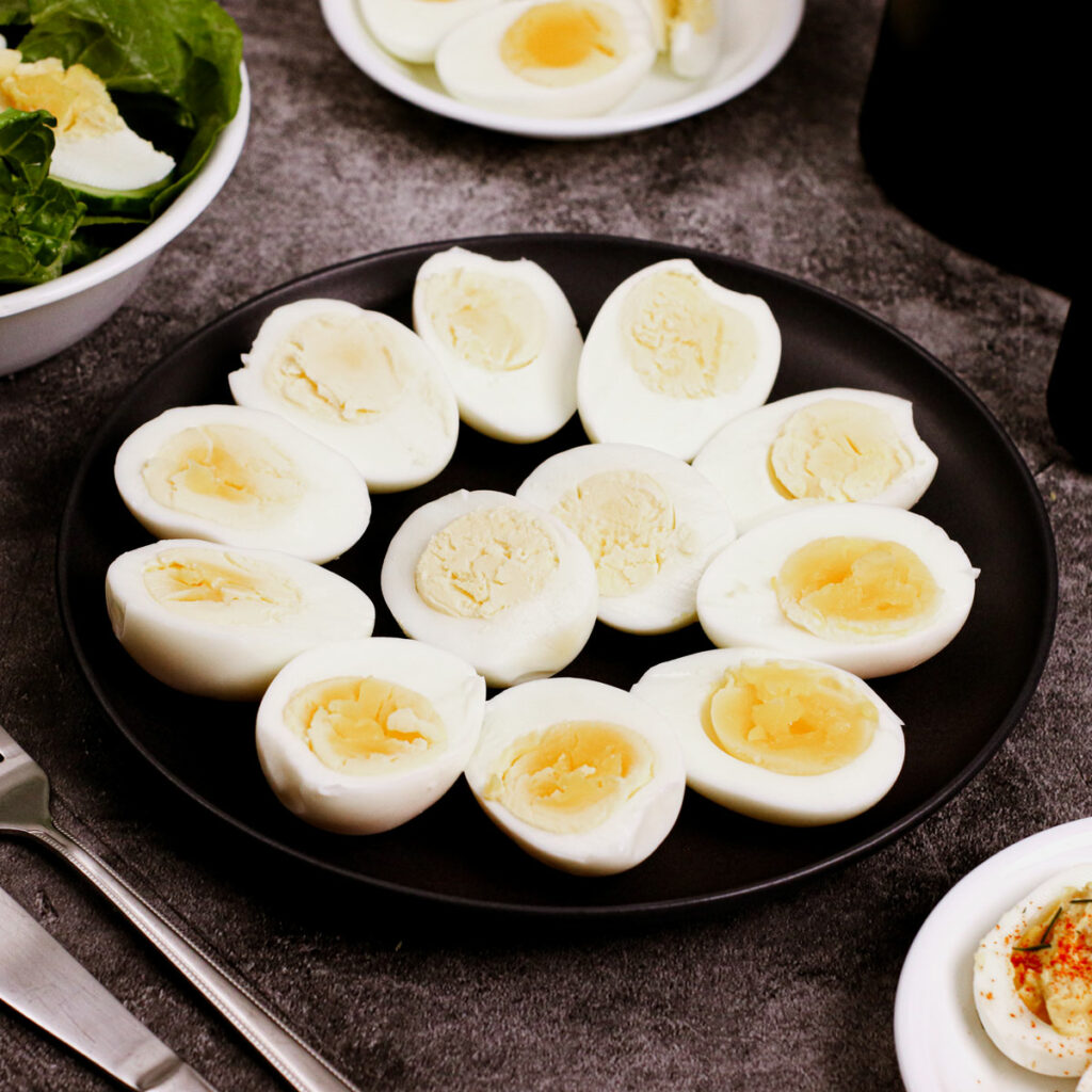 Air fryer hard boiled eggs served on a black plate