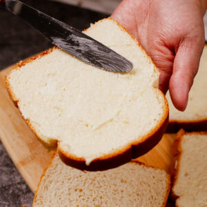 Spreading butter to bread slice