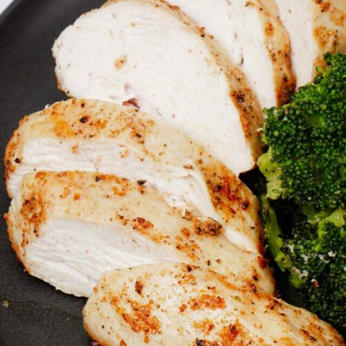 Air fryer frozen chicken breast recipe, close up shot, served with air fryer roasted broccoli