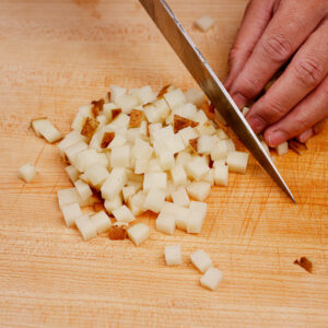 Dicing potatoes on a chopping board