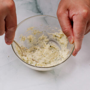 Mixing garlic butter spread.