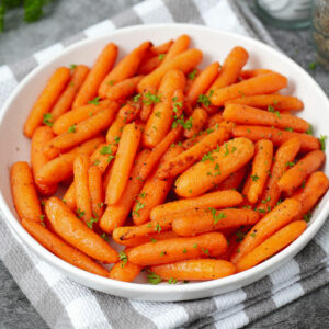 Air fried baby carrots with garnish of fresh parsley.