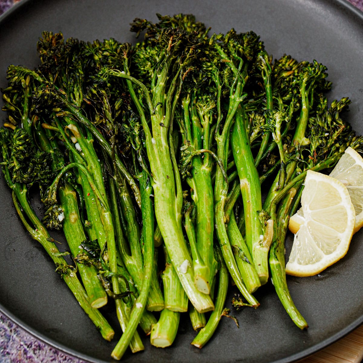 Air fried broccolini with lemon wedges