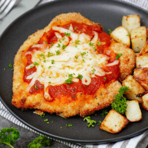 Air fried chicken parmesan with diced potatoes.
