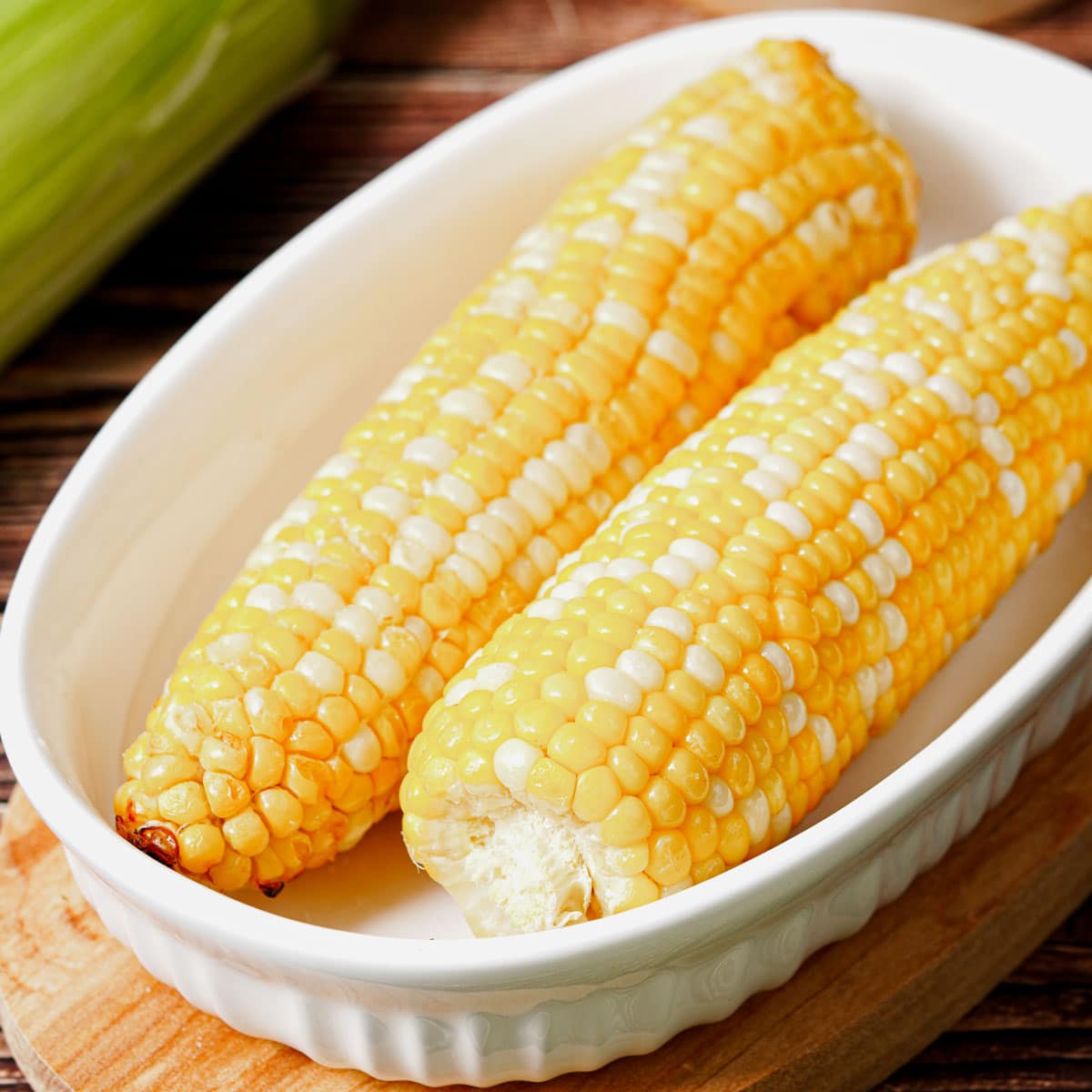 Air fried corn on the cob served in a small baking dish.